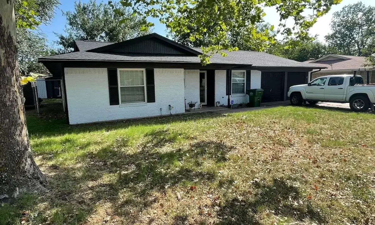 Professional roofing crew working on a residential roof in Carlsbad